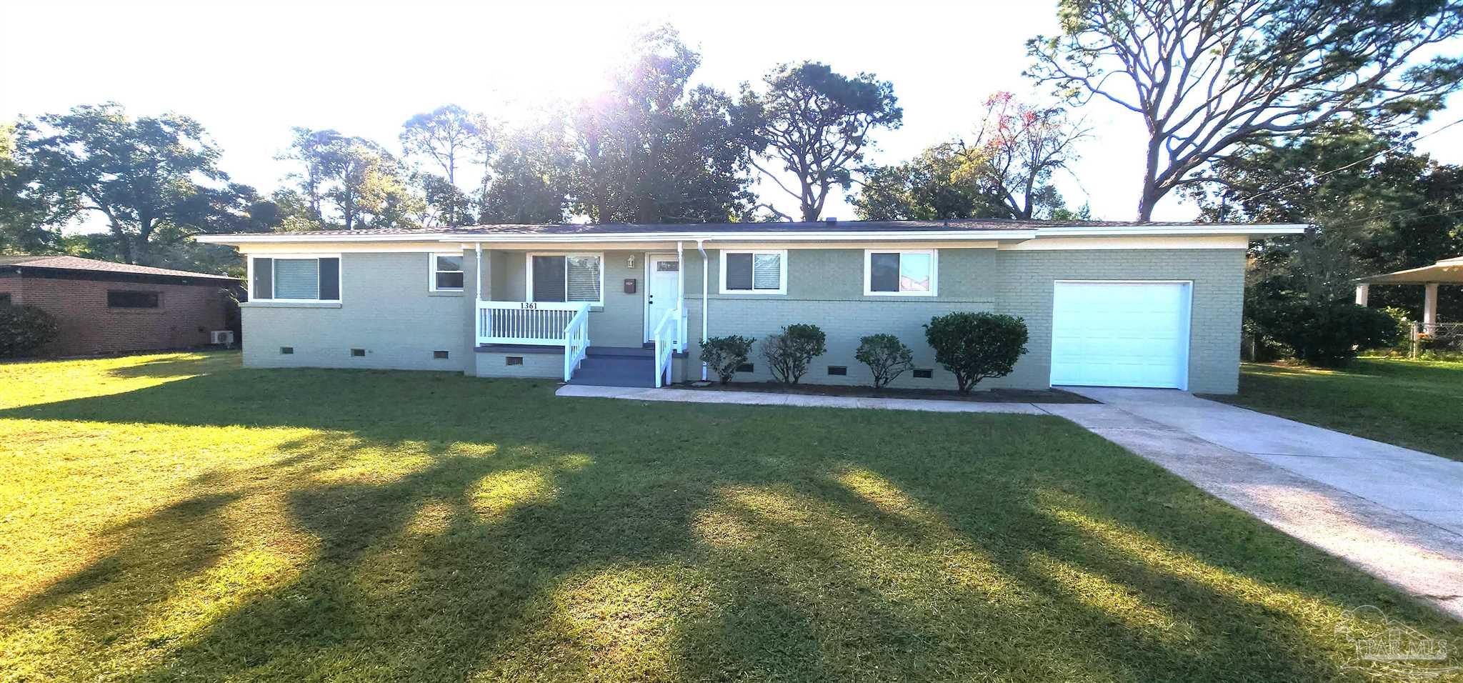 a view of a house with a yard and swimming pool