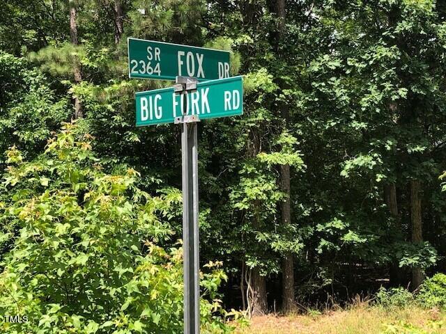 a street sign that is sitting in a forest