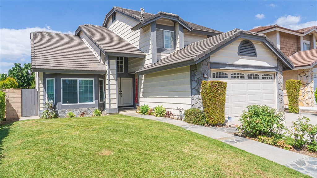 a front view of a house with a yard and garage