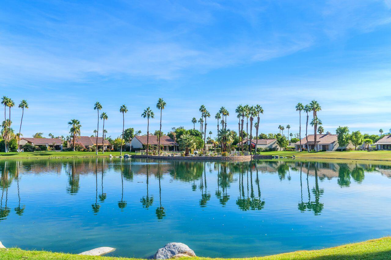 a view of a lake with a table and chairs