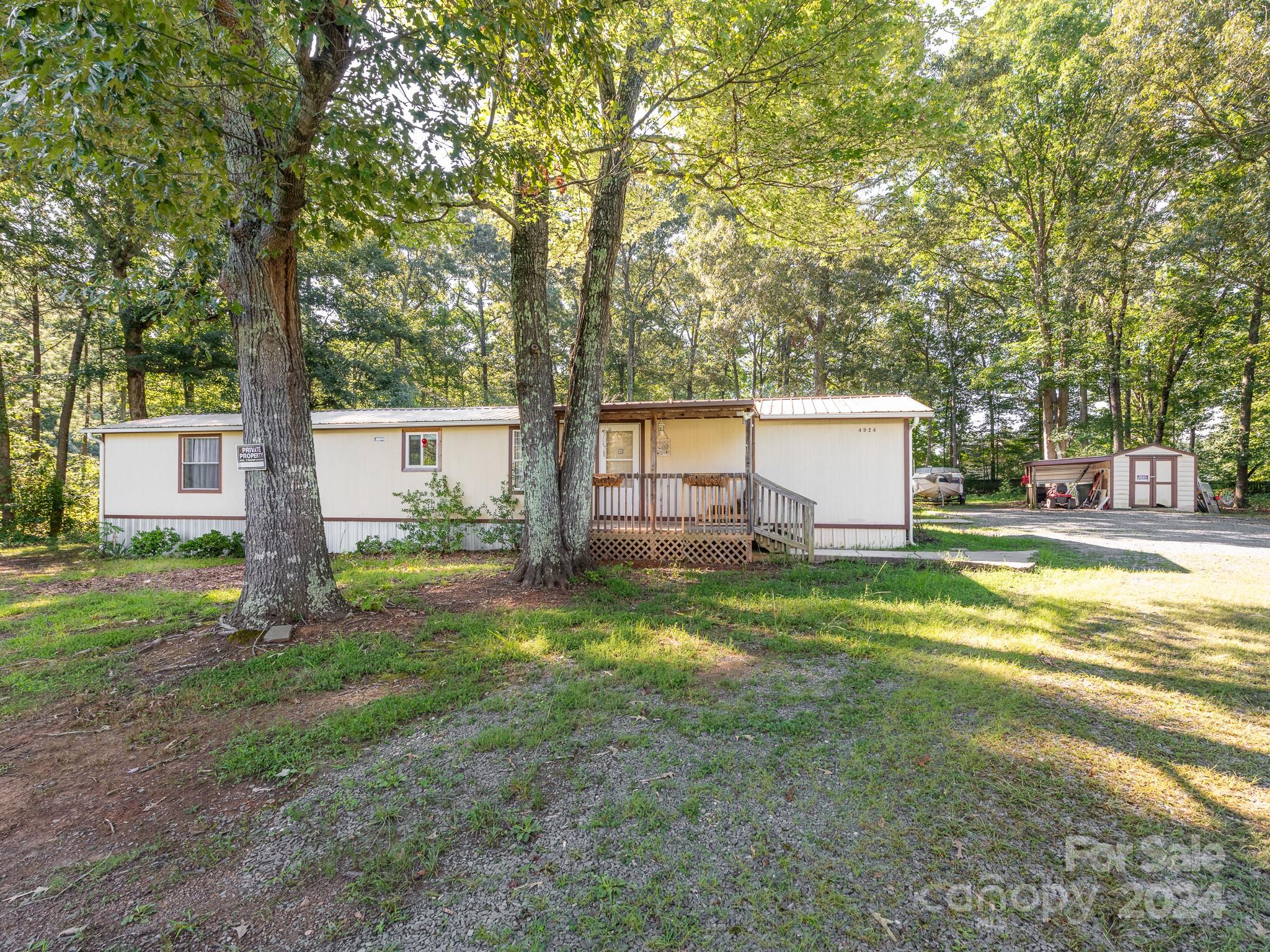 a view of a house with backyard and a tree