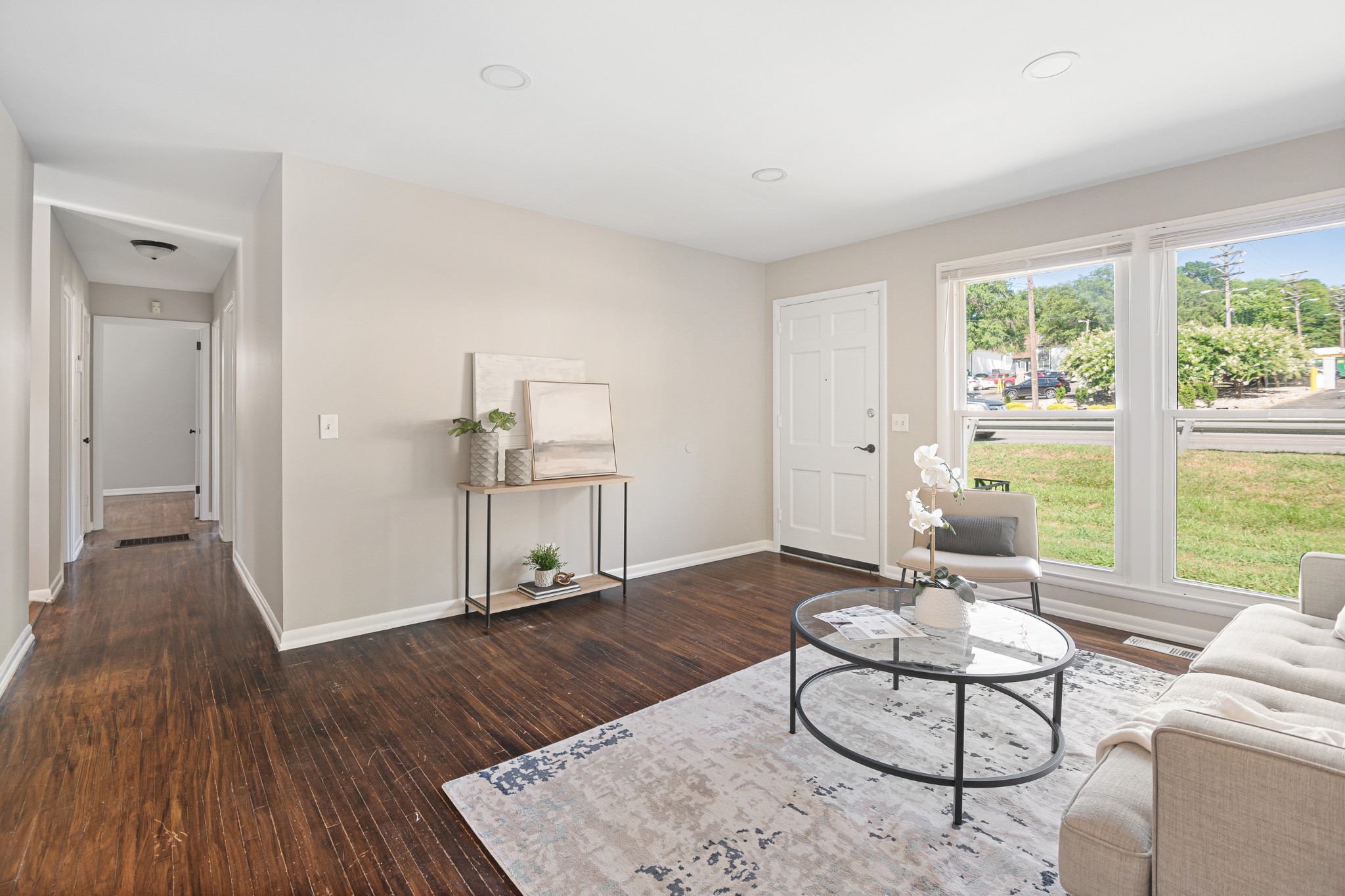 a living room with furniture and a wooden floor