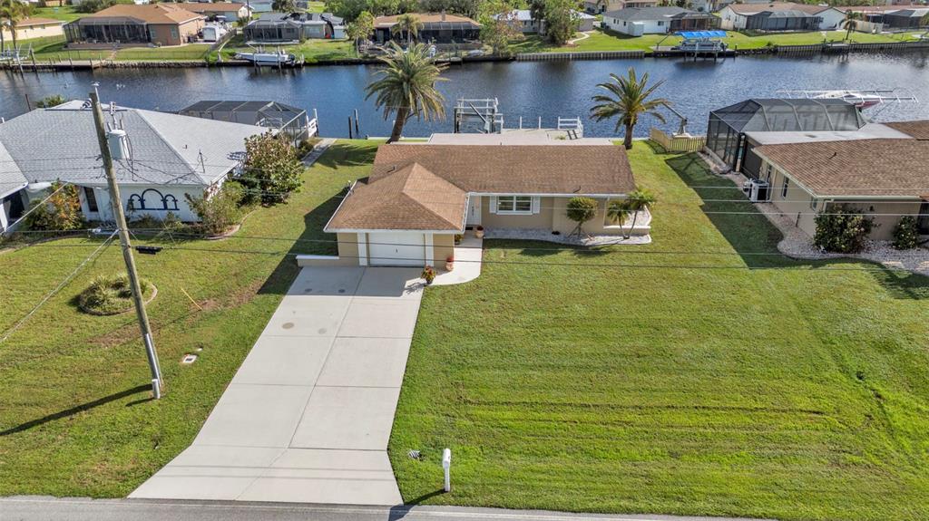 a aerial view of a house with a yard and potted plants