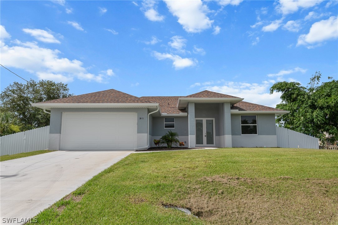 a front view of a house with yard and garage