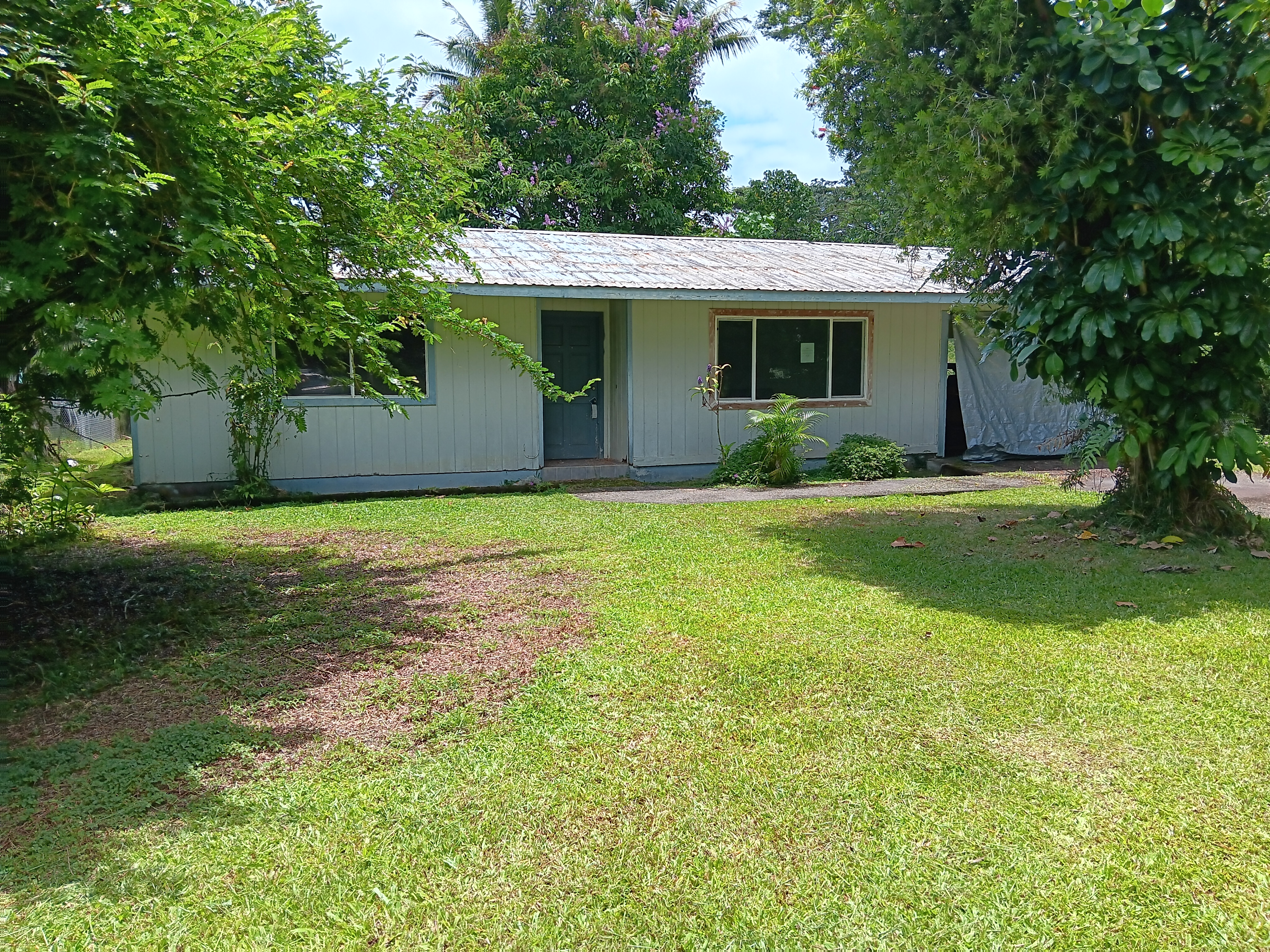 a view of a house with a yard and sitting area