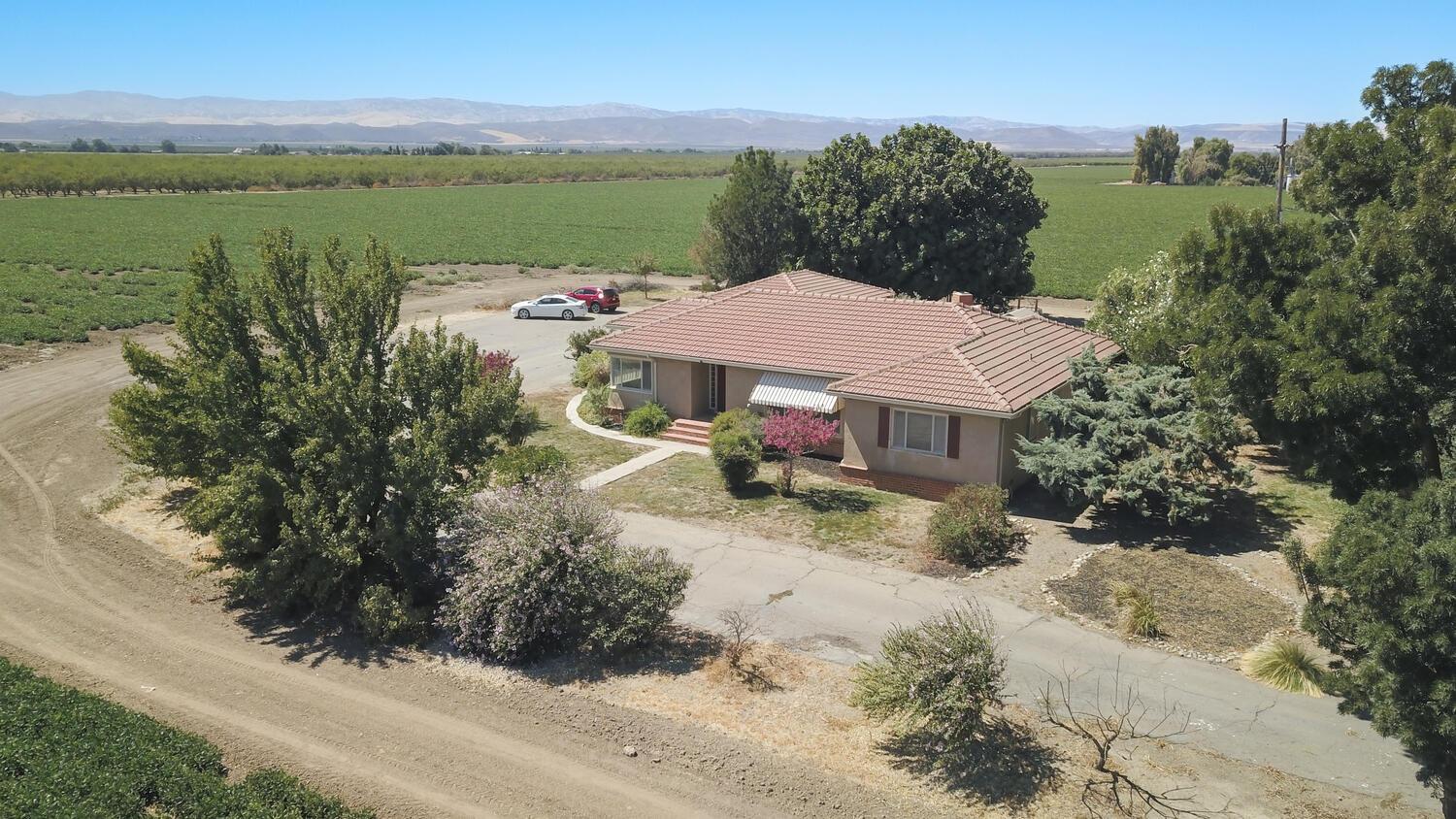 an aerial view of a house with garden space and outdoor seating