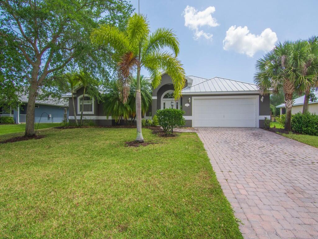 a front view of house with yard and green space