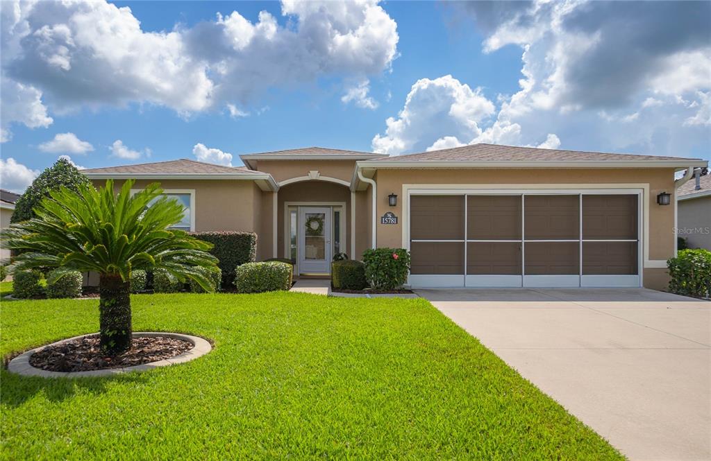 a front view of a house with a yard and garage