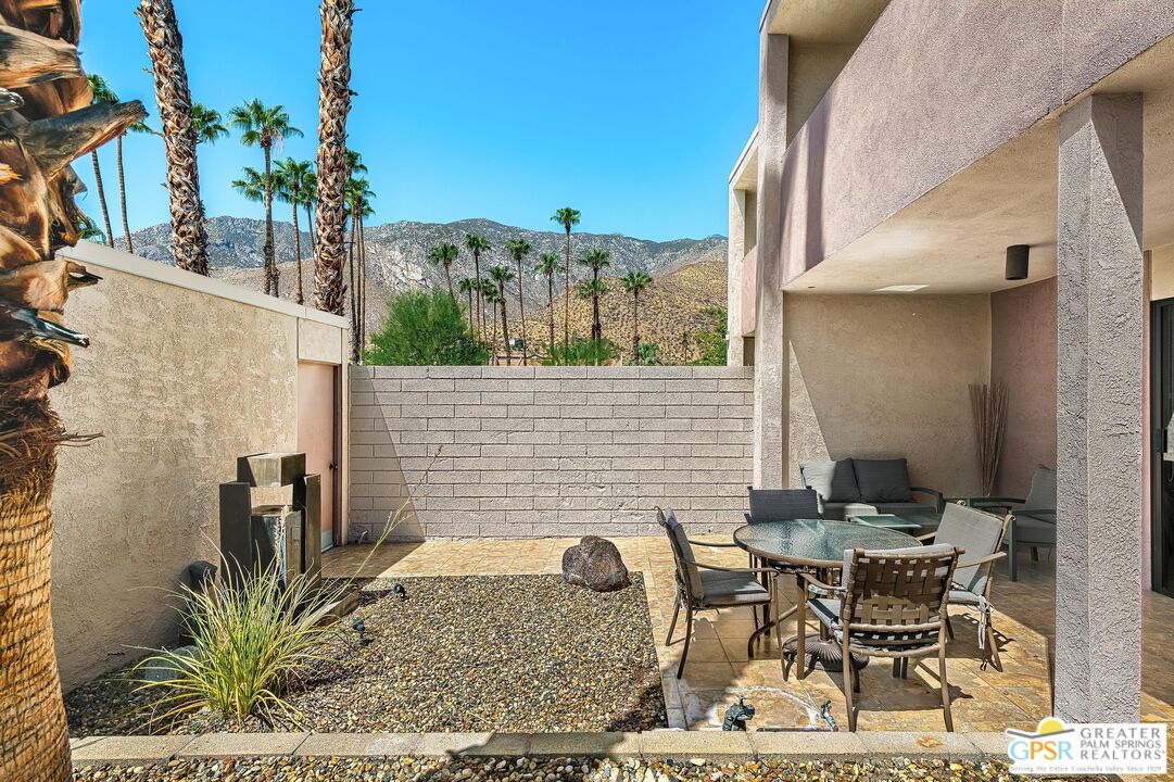 a backyard of a house with table and chairs