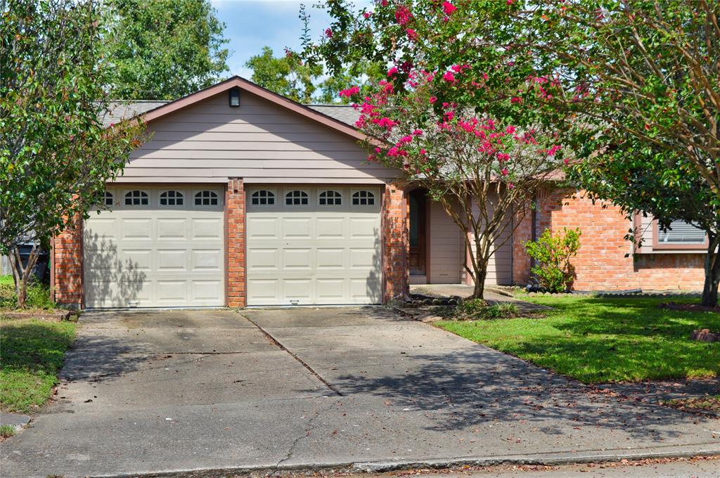 a small house with a tree in the yard