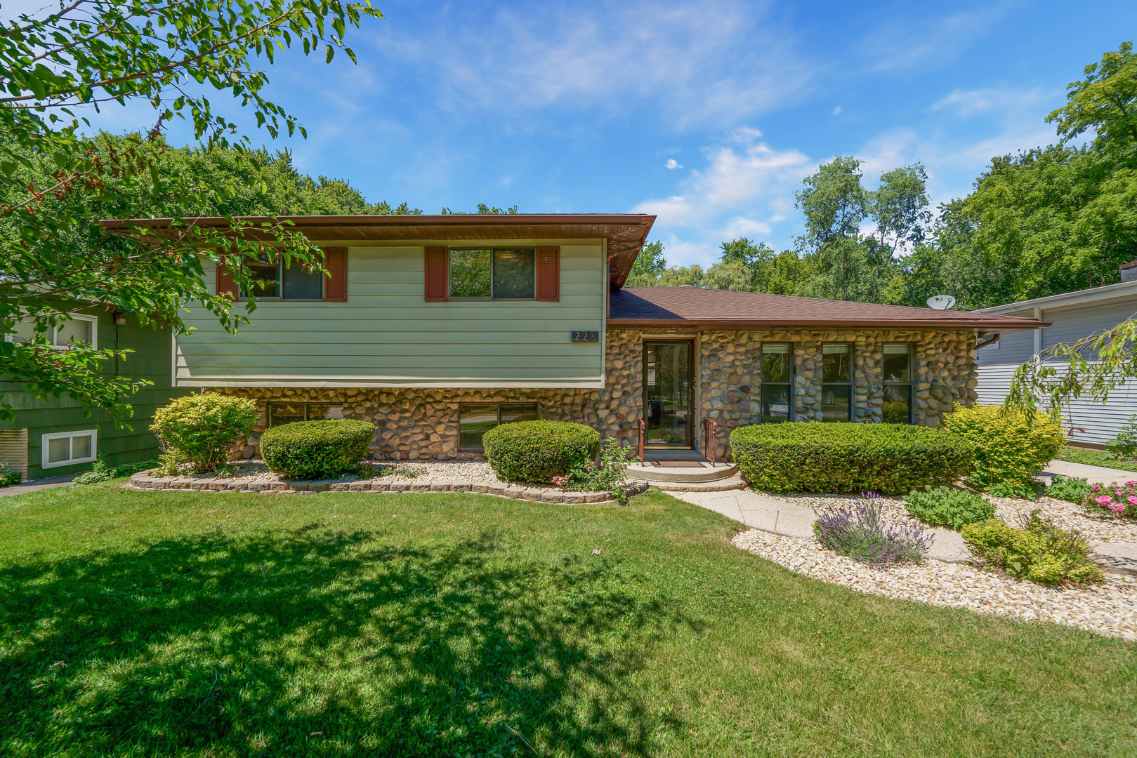 a view of house with backyard and outdoor seating