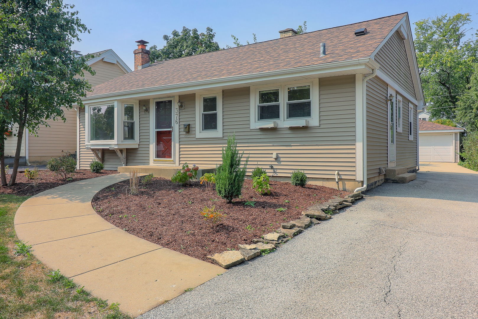 a front view of a house with garden