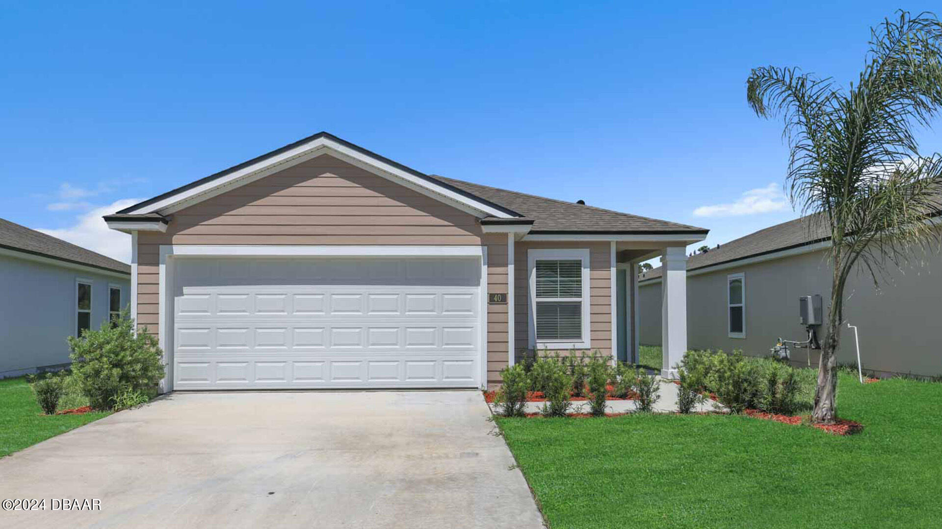 a front view of a house with a garden