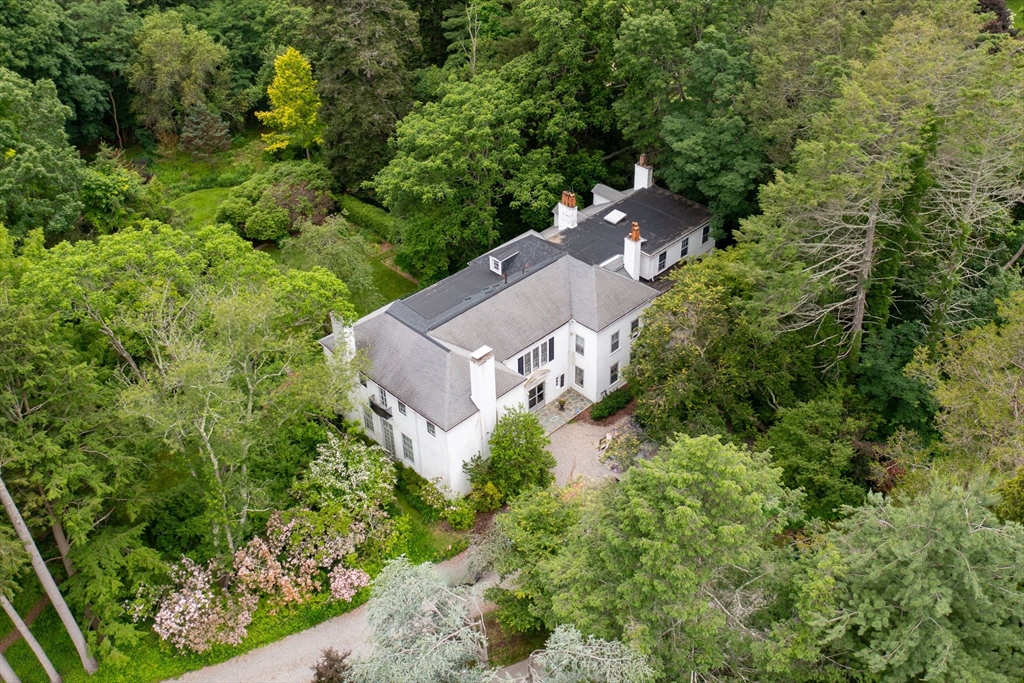 an aerial view of a house with a yard