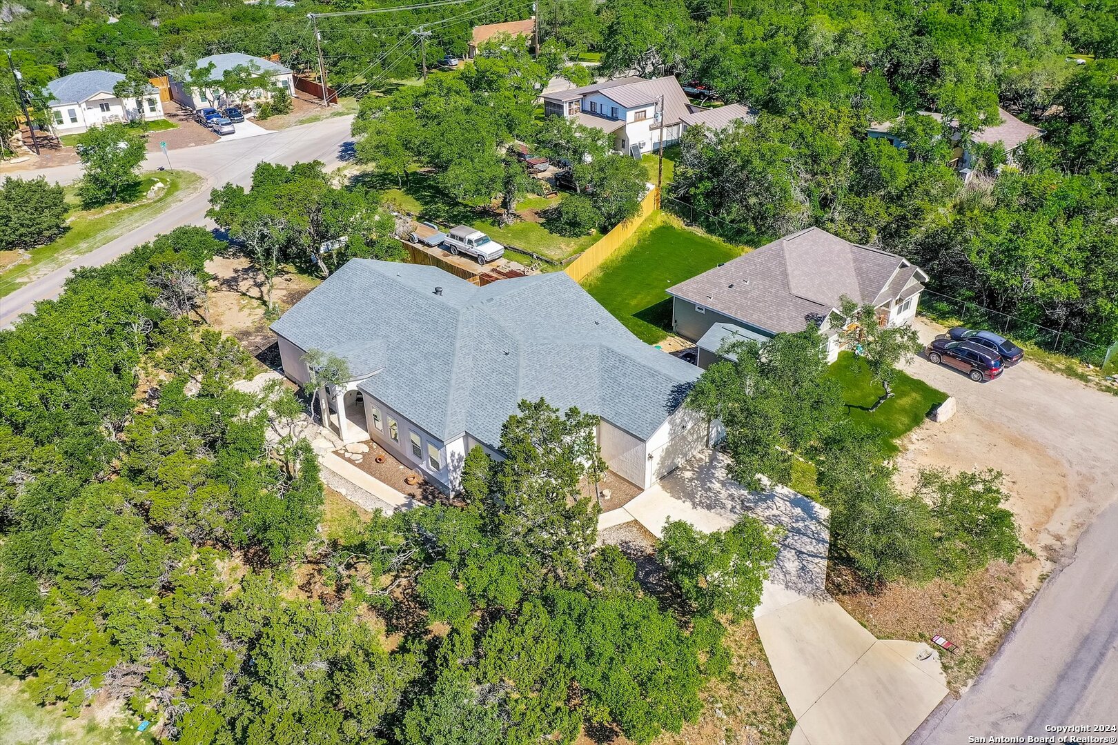 an aerial view of multiple houses with yard