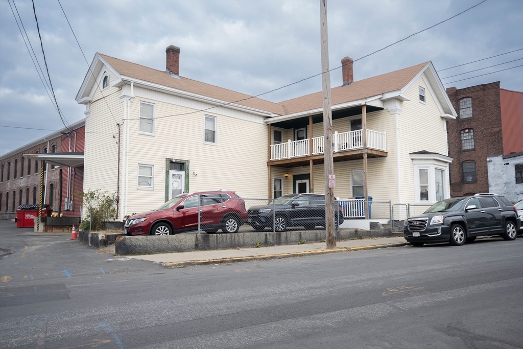 a car parked in front of a white building