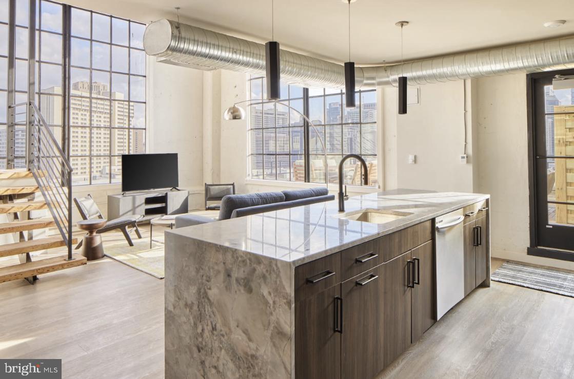 a kitchen with counter top space and windows