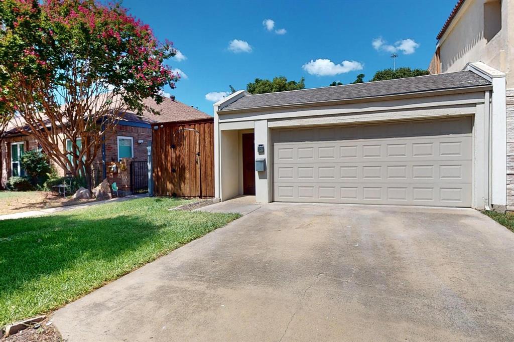 a view of a house with a yard and garage