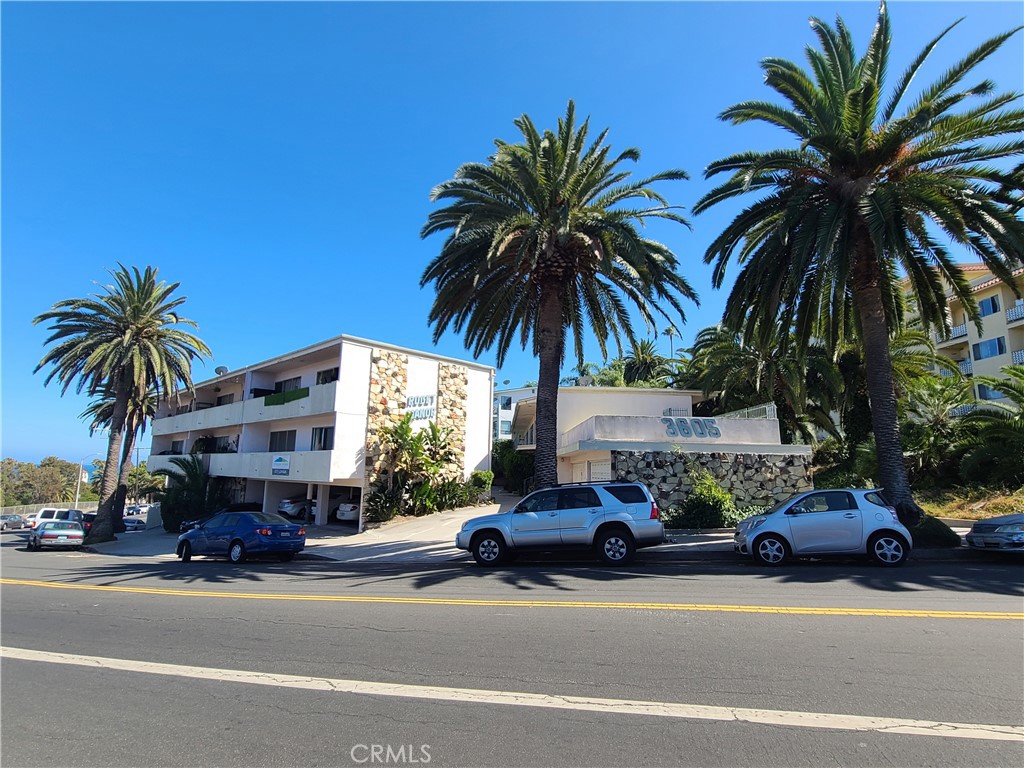 a couple of cars parked in front of a house