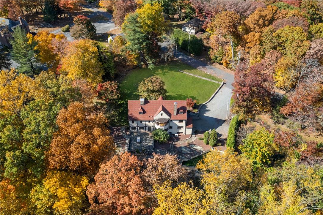 an aerial view of a house with a yard and lake view