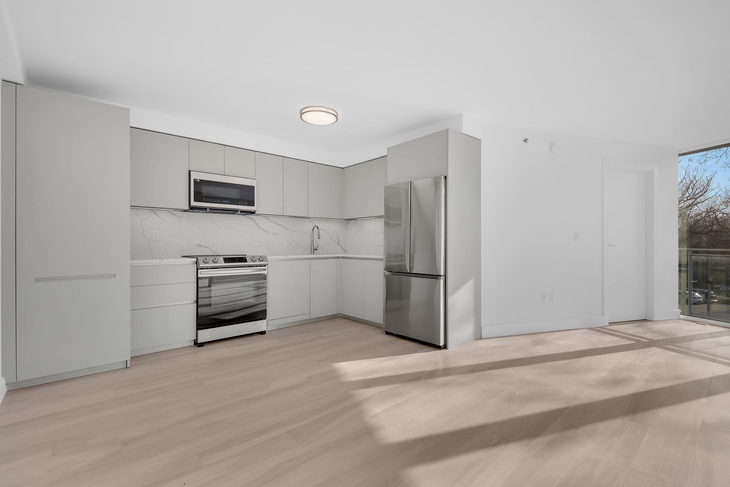 a kitchen with refrigerator cabinets and a refrigerator