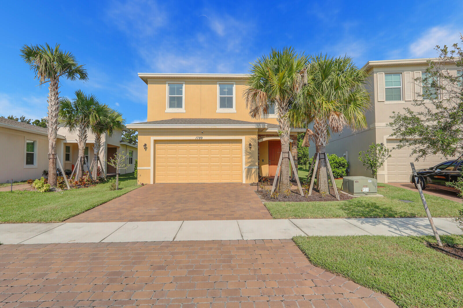 a front view of a house with a yard and garage