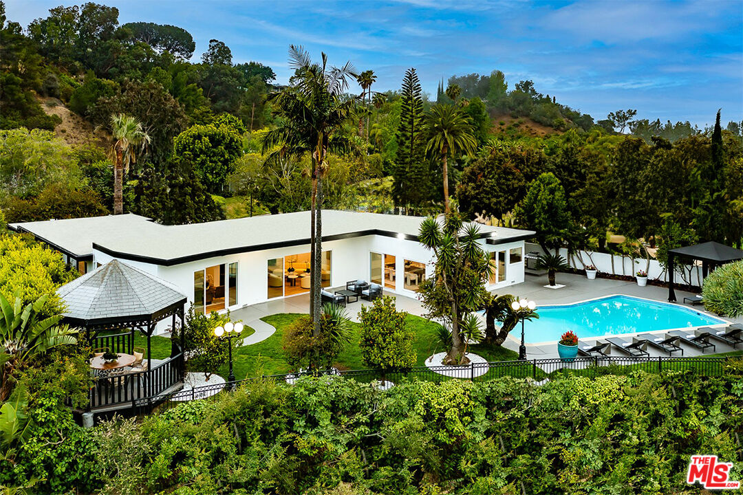 an aerial view of a house with yard swimming pool and outdoor seating