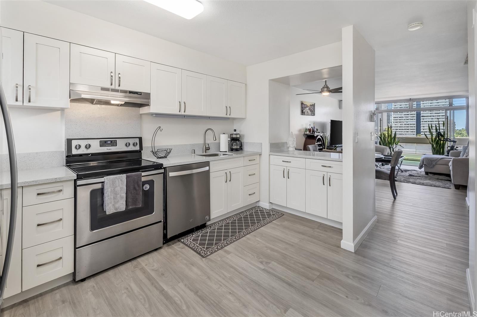 a kitchen with stainless steel appliances a white stove top oven and cabinets