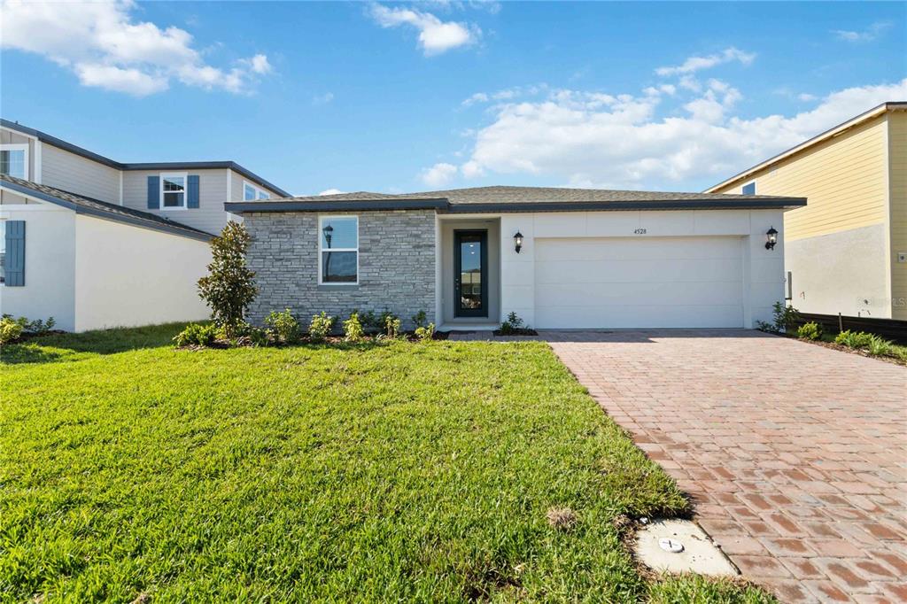 a front view of a house with a yard and garage