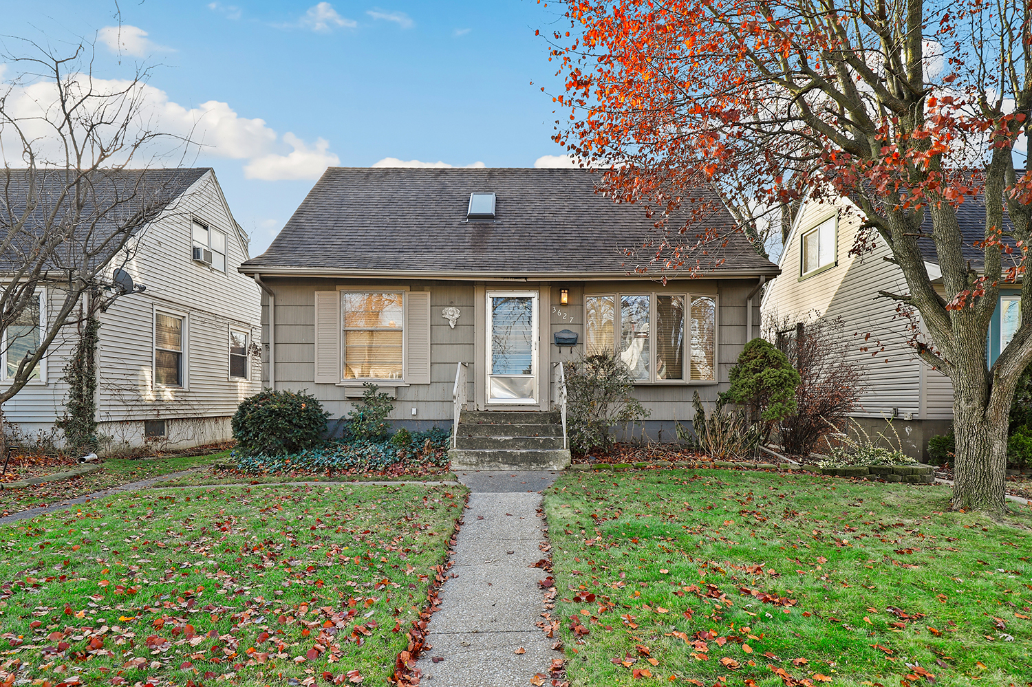 a front view of house with yard and green space