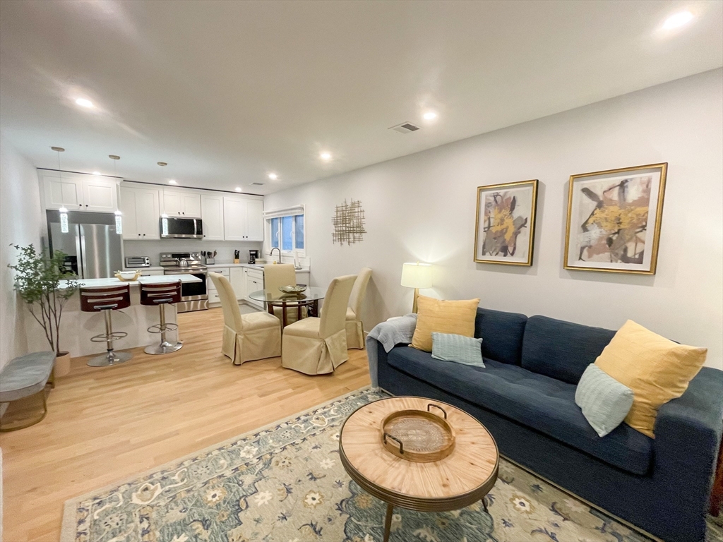 a living room with furniture kitchen and a table