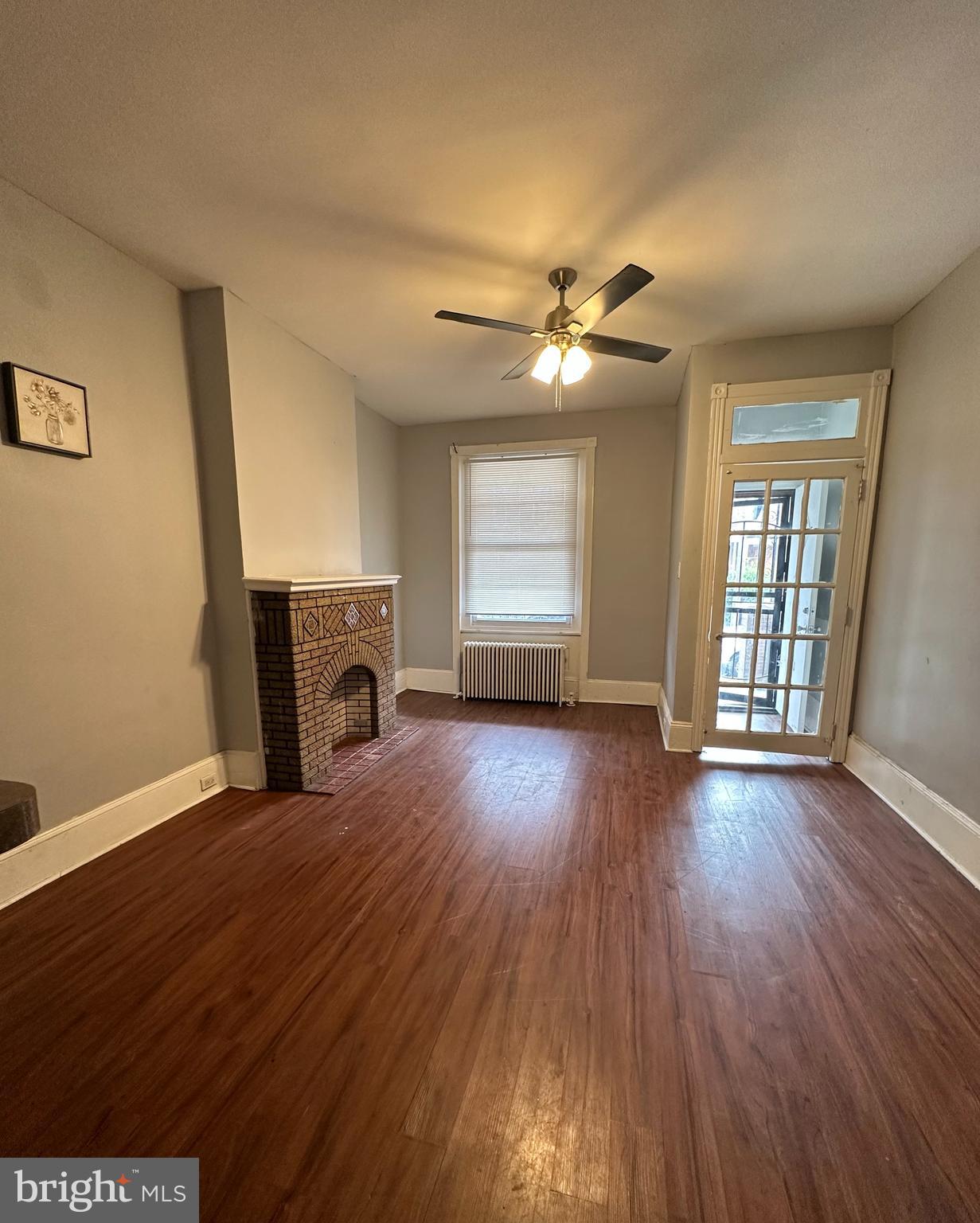 wooden floor in an empty room with a fireplace