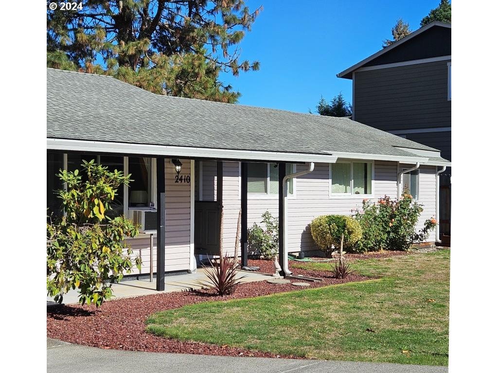 a front view of a house with garden and porch