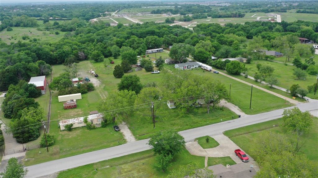 an aerial view of residential houses with outdoor space and street view