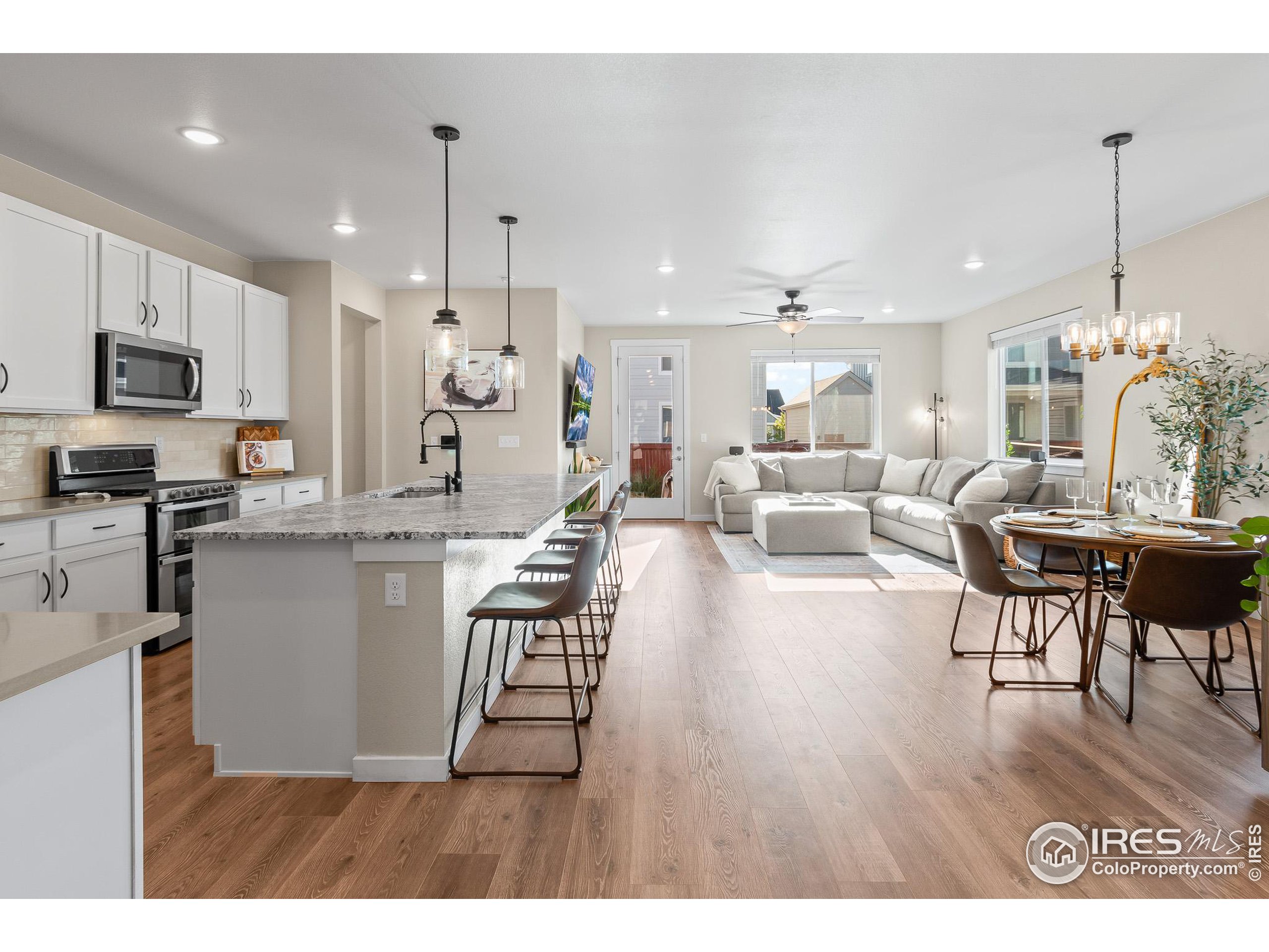 a living room with kitchen island furniture and a flat screen tv