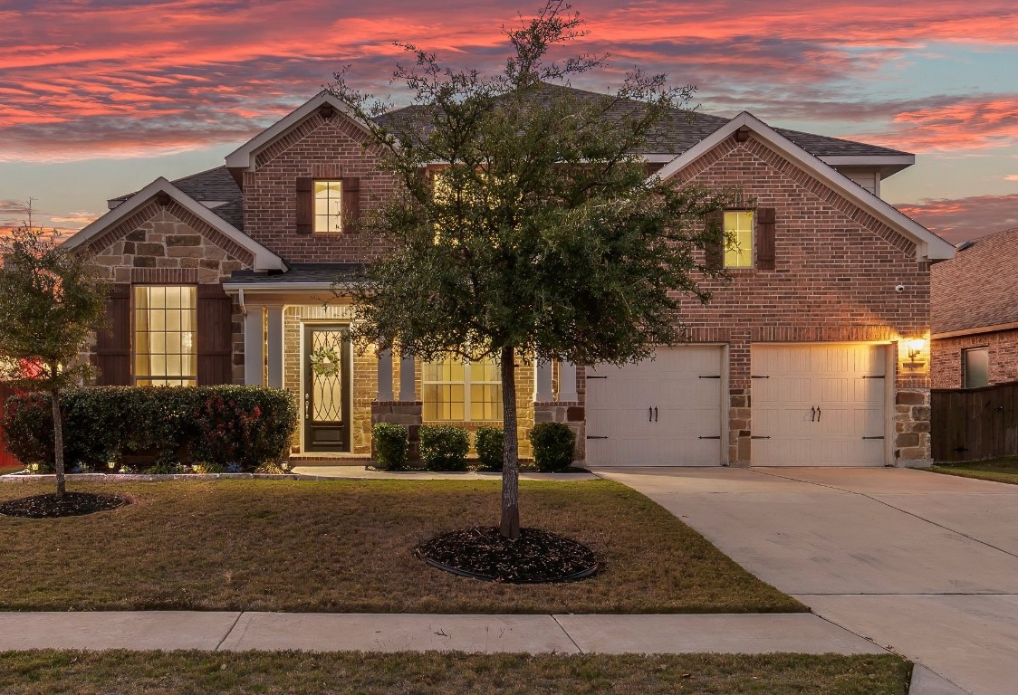 a front view of a house with a yard