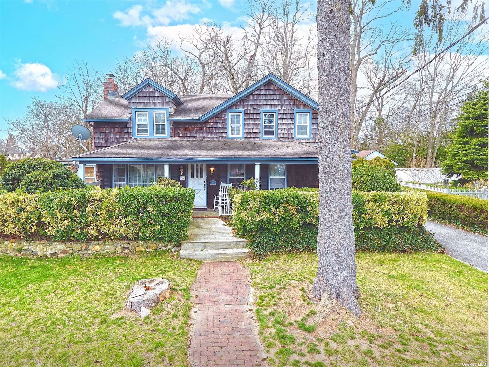 a front view of a house with a yard and fountain