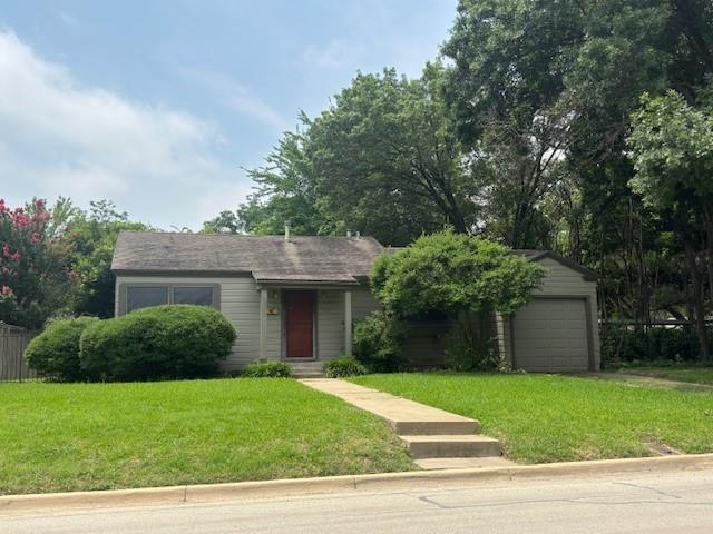 a view of a house with a yard and tree s