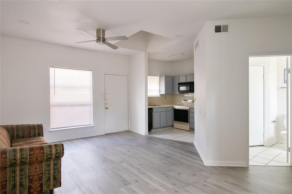 a view of kitchen with livingroom and wooden floor