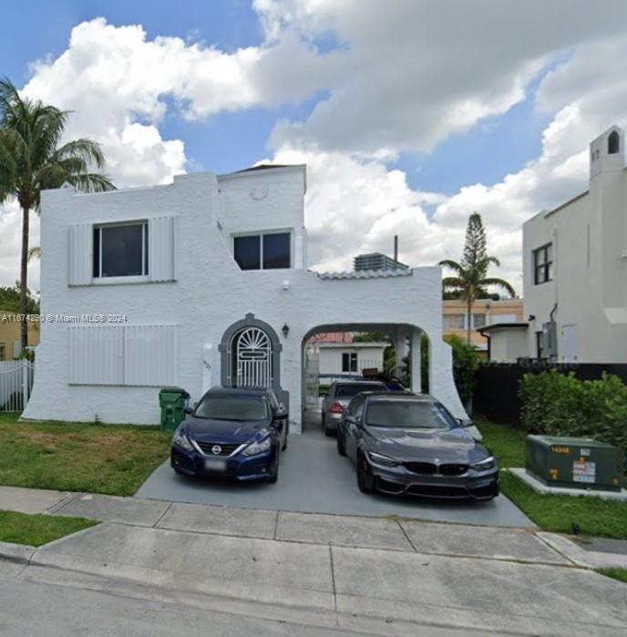 a view of a car parked front of a house