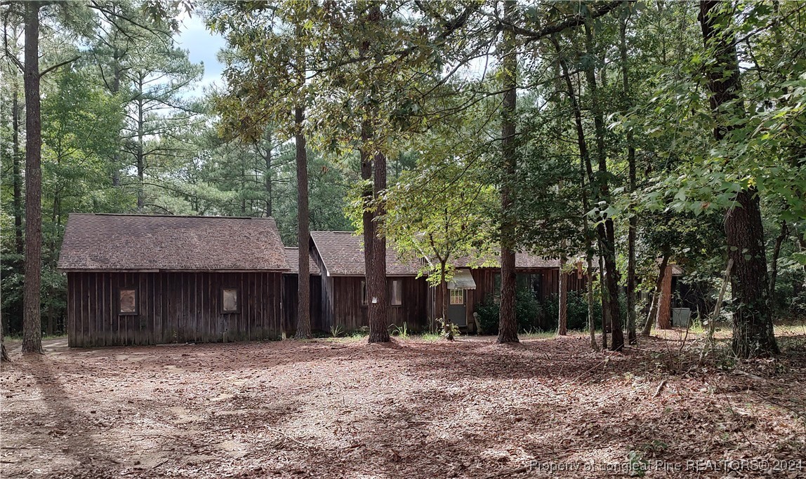 a front view of a house with a yard and trees