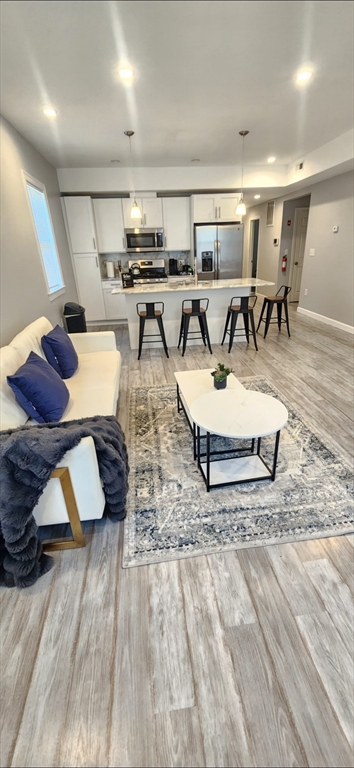 a living room with lots of furniture and a wooden floor