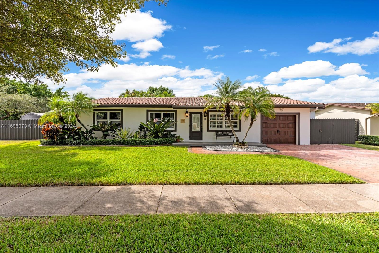 a front view of a house with a yard and a garage