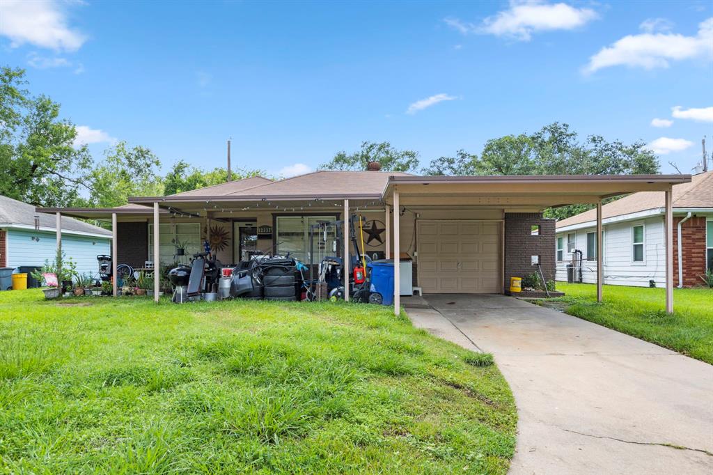 a view of a house with a yard and sitting area