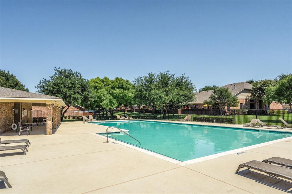 a view of a swimming pool with a patio and a yard