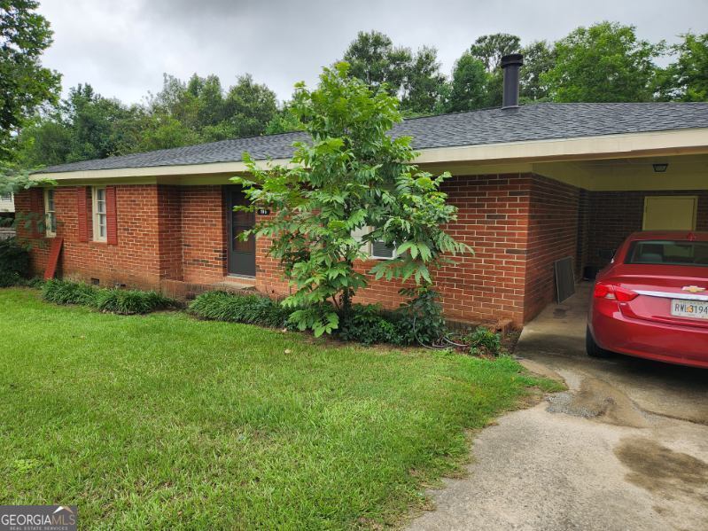 a front view of a house with a garden