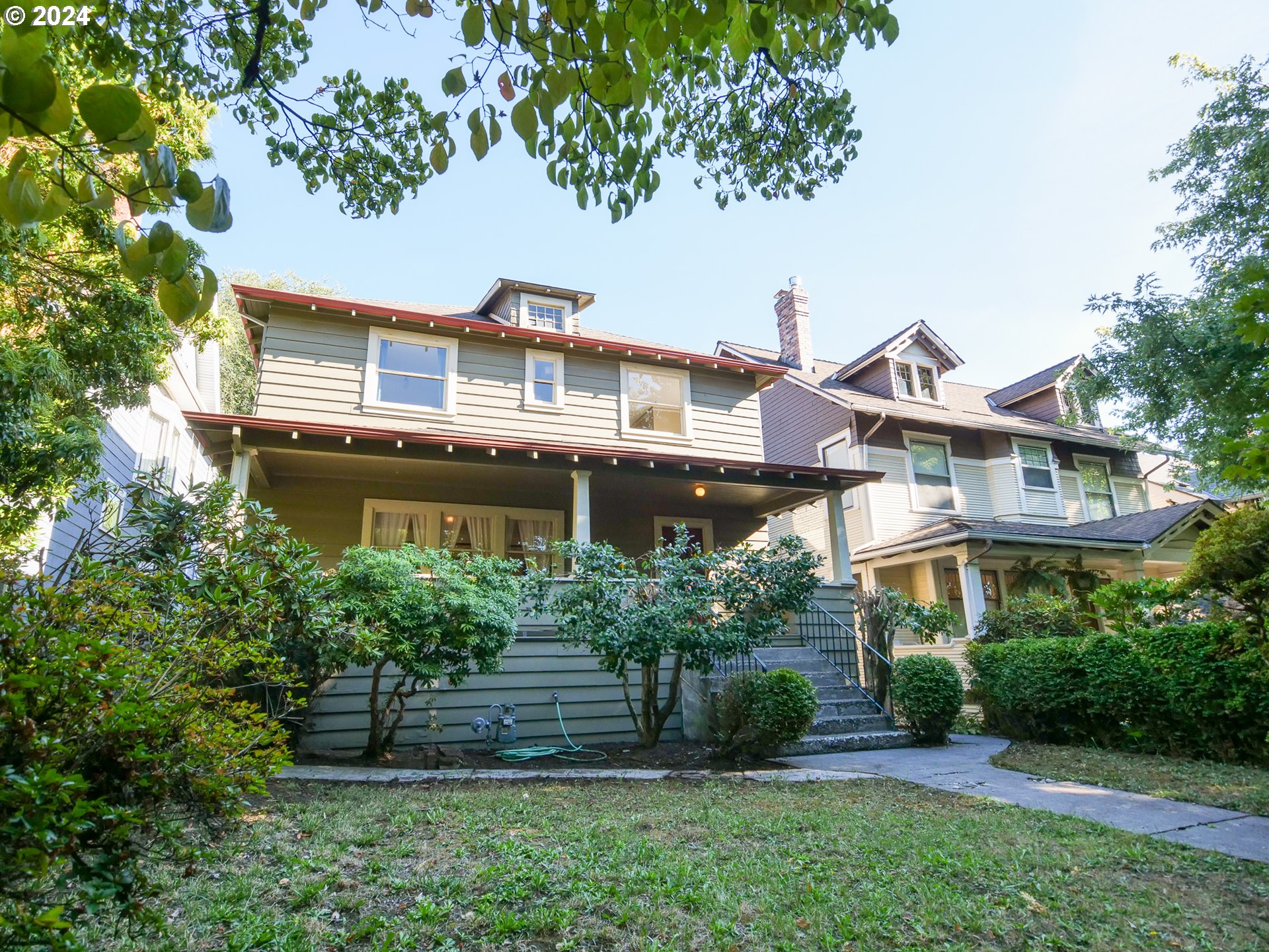 a front view of a house with a garden