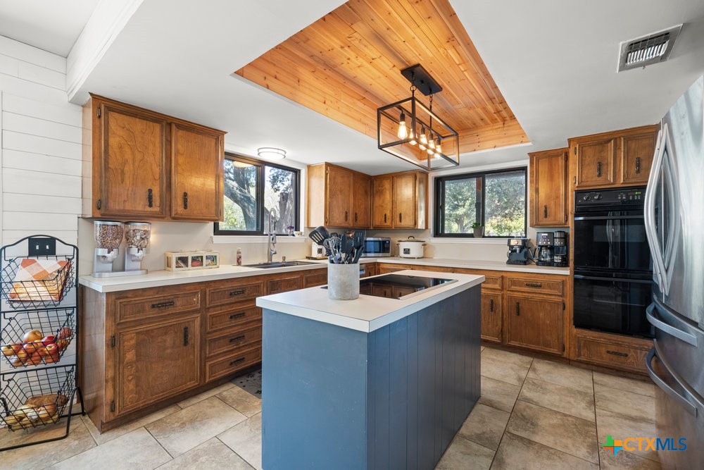 a kitchen with a sink stove and cabinets