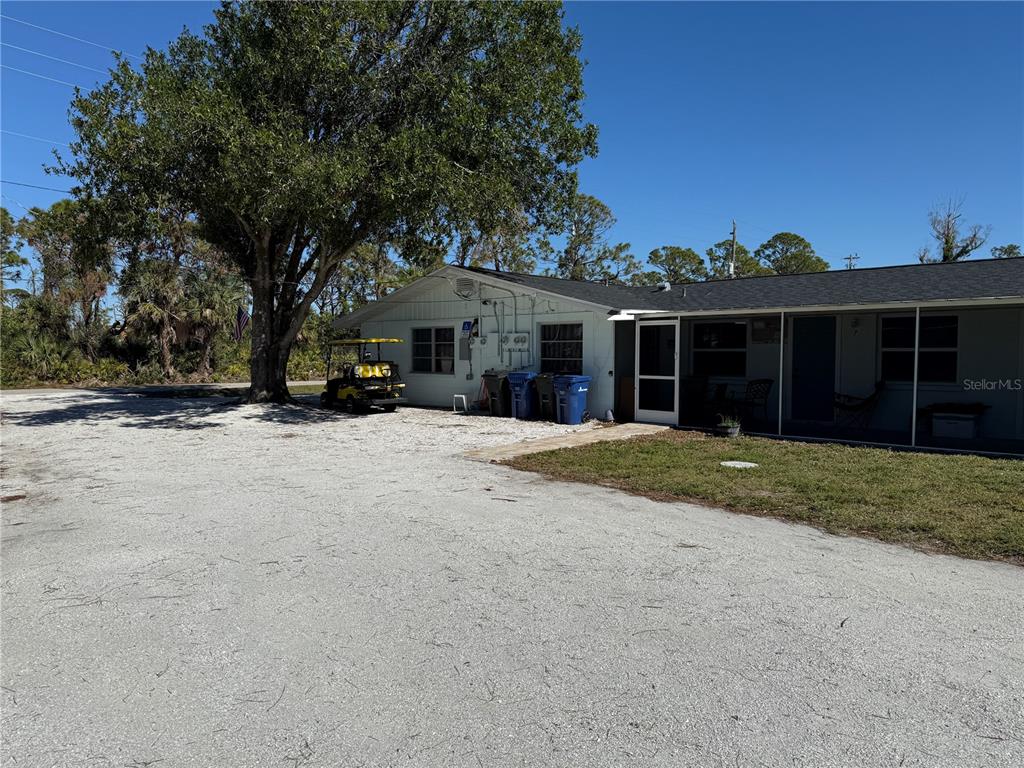 front view of a house with a yard and trees