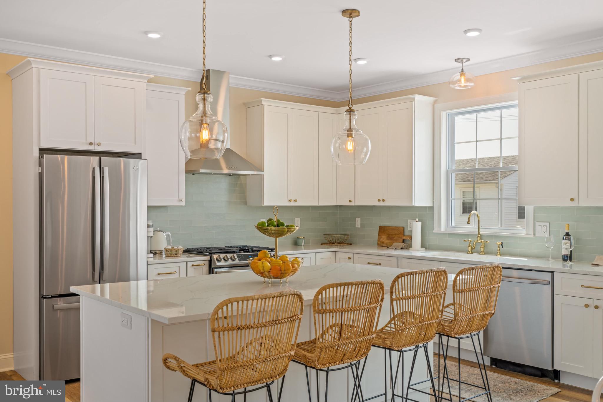 a kitchen with stainless steel appliances granite countertop a sink refrigerator and cabinets